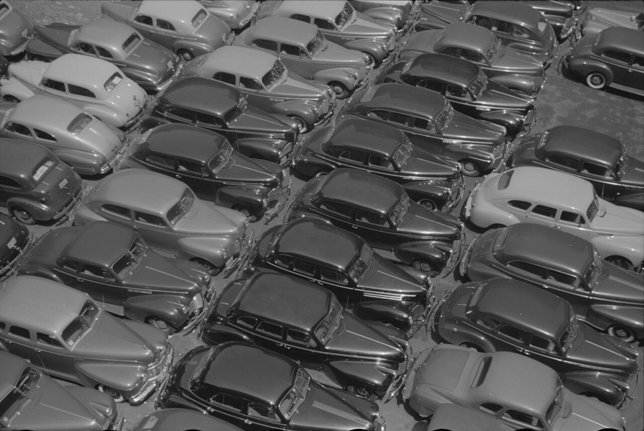 John Vachon photograph, July 1941: rows of parked automobiles filling a Chicago lot, gleaming under summer light.